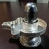 Parad Shivling weighing 200 grams (Shape - Flat base and spherical top ) seated on a pure Silver Metal yoni