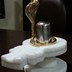 Parad Shivling weighing 1.25 kgs (Dimension : 3 inch height , 6 inch Circumference) seated in a White Marble yoni along with a Golden Panchdhatu Serpant